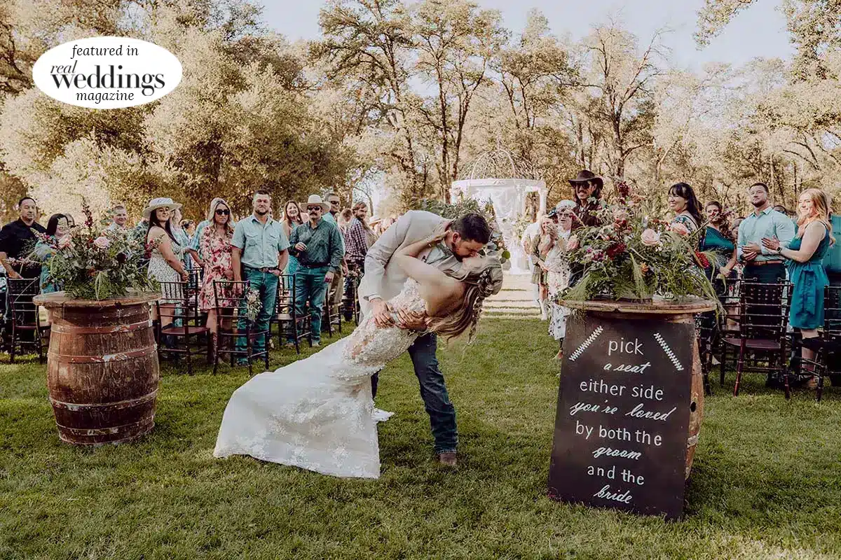 Kasey and Maddy kiss at the end of the aisle. Photo by Dream Capture Studios
