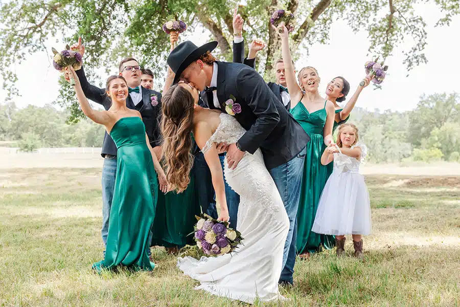 kiss-kt Kaylee and Tuff kissing as their wedding party cheers them on