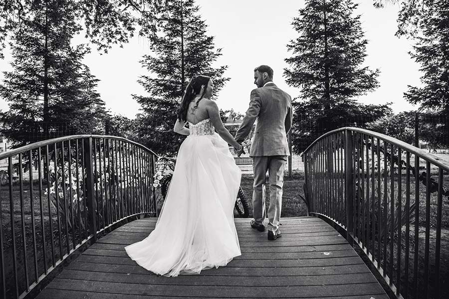 2025-05-03-183059-DSCF7023 black and white picture of couple crossing footbridge
