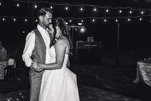 2025-05-03-220200-9Y1A0307 black and white of couple dancing under market lights