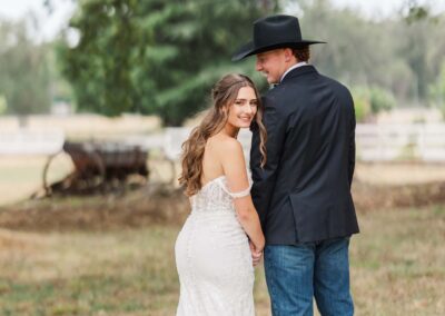 Couple in front of vintage farm equipment
