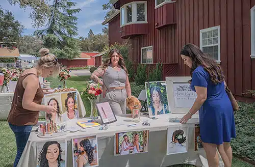 Wedding expo guests exploring a beauty vendor's booth
