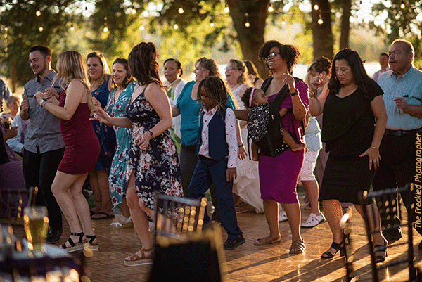 Wedding guests having fun on the dance floor at Rough & Ready Vineyards after making it onto the wedding guest list. Photo by The Freckled Photographer