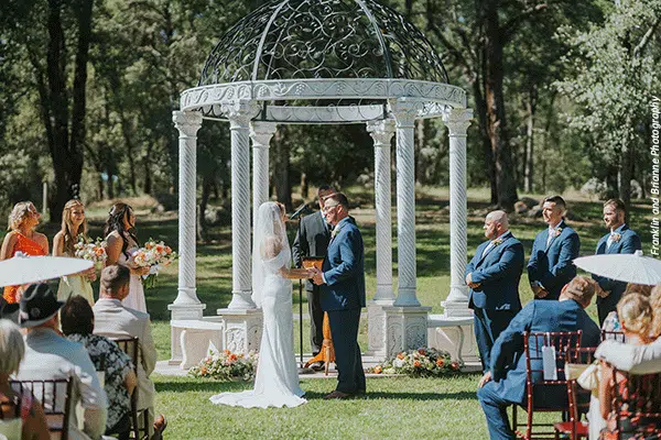 choosing-venue Happy couple exchanging vows by the gazebo after choosing a wedding venue at Rough & Ready Vineyards