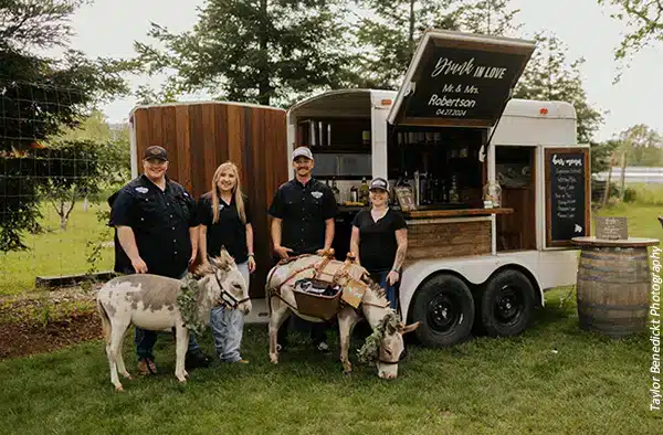 Wedding vendors from The Drunken Burro ready to serve drinks and fun with burros at a wedding. Photo by Taylor Benedickt Photography