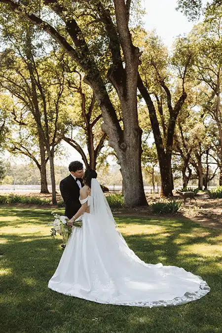 Wedding kiss at outdoor wedding venue with lodging Rough and Ready Vineyards under the heritage oaks